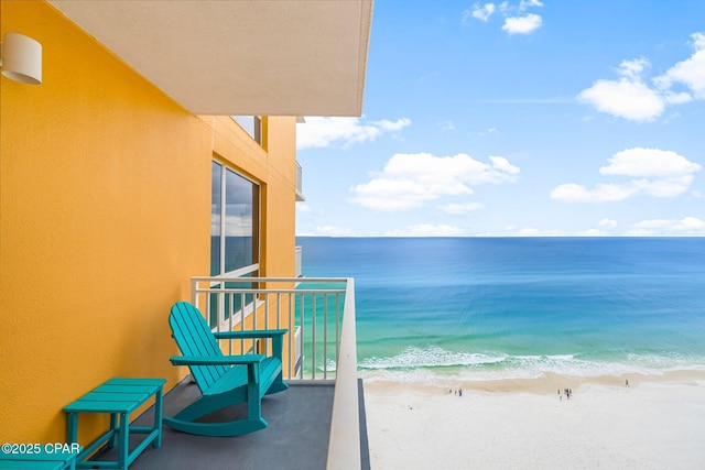 balcony with a view of the beach and a water view