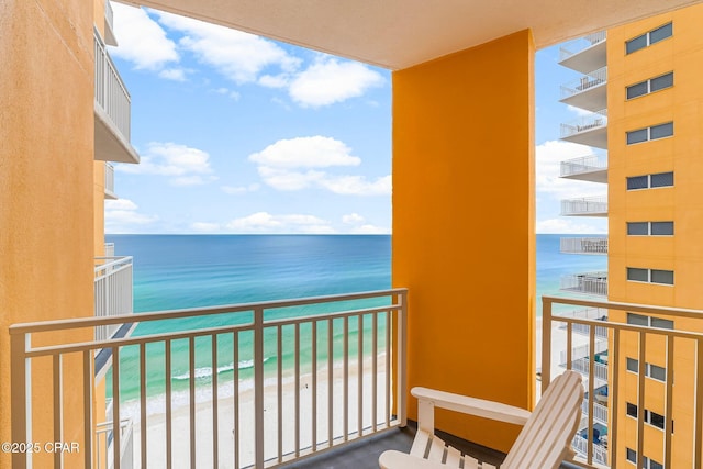 balcony with a view of the beach and a water view