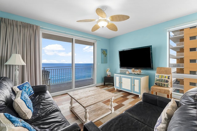 living room with baseboards, ceiling fan, and wood finished floors