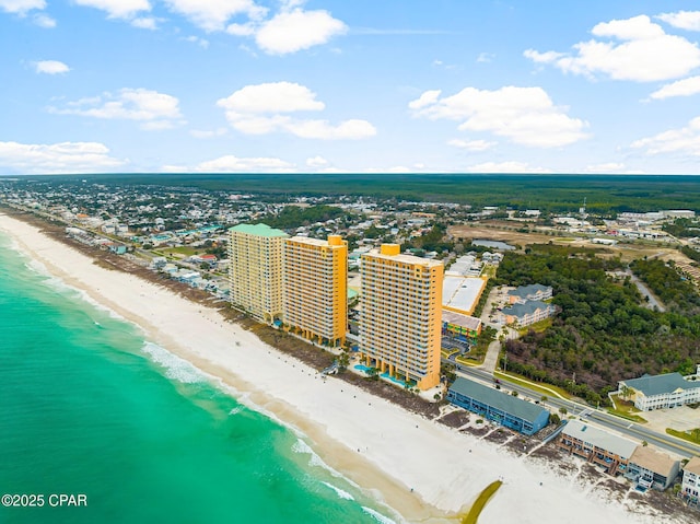 birds eye view of property featuring a city view, a view of the beach, and a water view