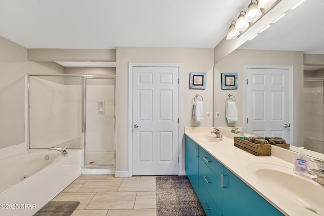 bathroom featuring a stall shower, a sink, and double vanity