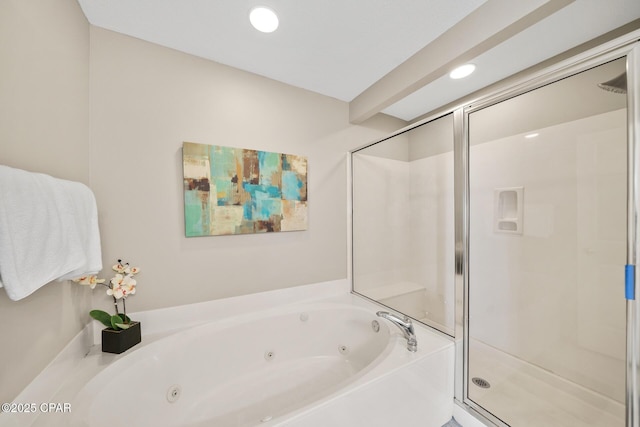 bathroom with a tub with jets, a shower stall, and recessed lighting