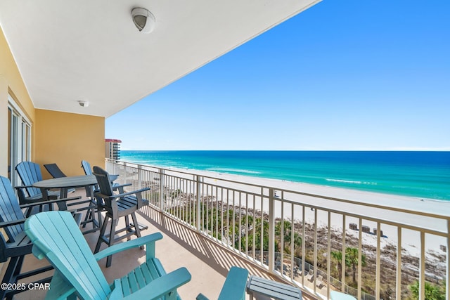 balcony featuring a water view and a view of the beach