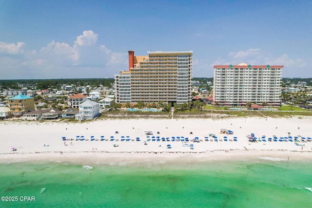 aerial view with a water view, a view of the beach, and a city view