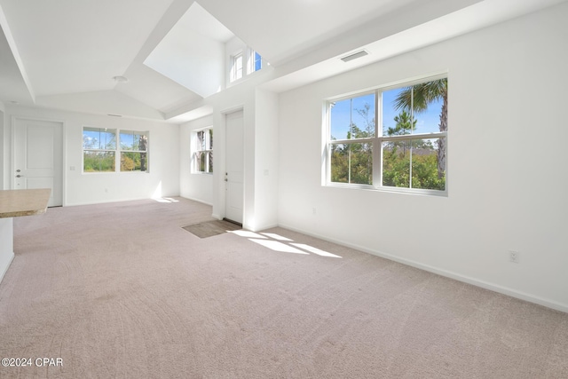 unfurnished living room featuring vaulted ceiling, carpet flooring, visible vents, and baseboards