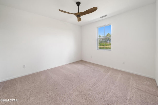 spare room featuring baseboards, visible vents, a ceiling fan, and carpet flooring