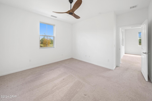 spare room with light carpet and visible vents