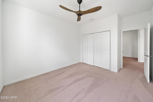 unfurnished bedroom featuring carpet floors, a closet, visible vents, and baseboards