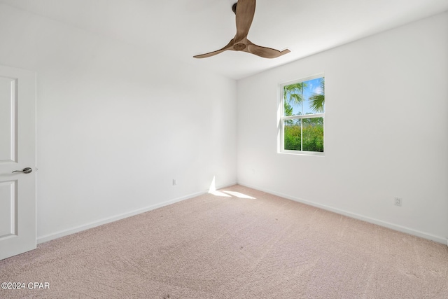 empty room with carpet, ceiling fan, and baseboards