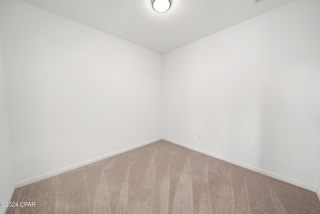 spare room with carpet flooring and baseboards