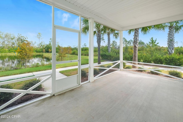 unfurnished sunroom with a water view