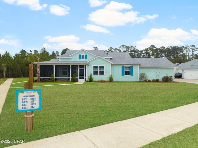 view of front facade featuring board and batten siding, a front yard, and a sunroom