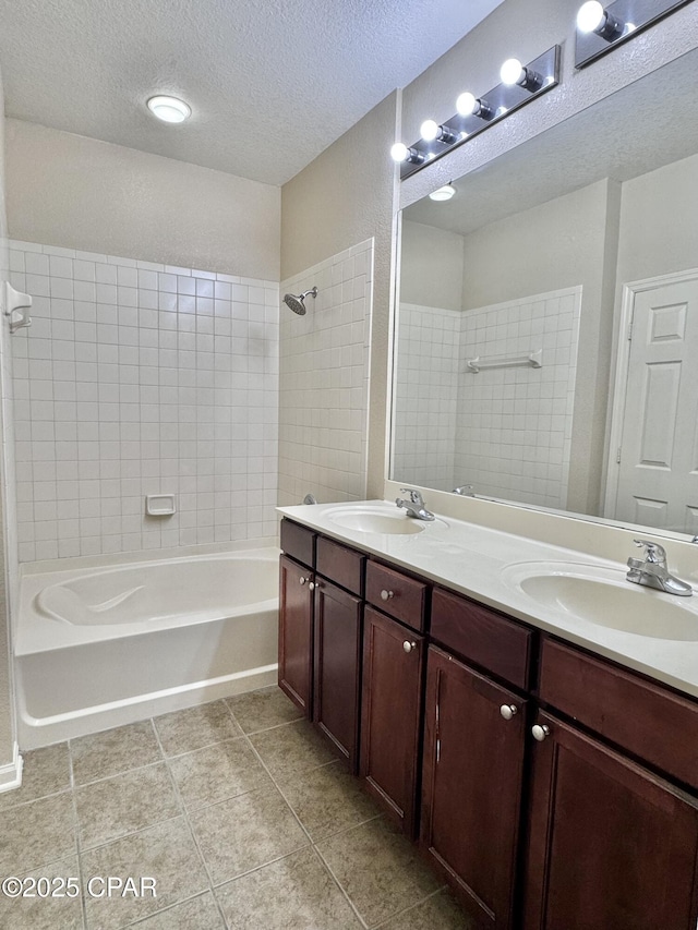 bathroom featuring shower / washtub combination, a sink, a textured ceiling, and double vanity