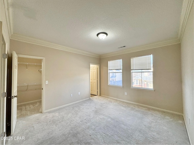 unfurnished bedroom featuring baseboards, visible vents, and crown molding