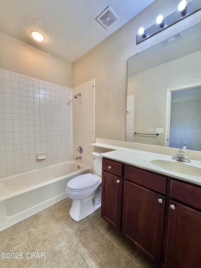 bathroom featuring tile patterned flooring, visible vents, a textured ceiling, and vanity