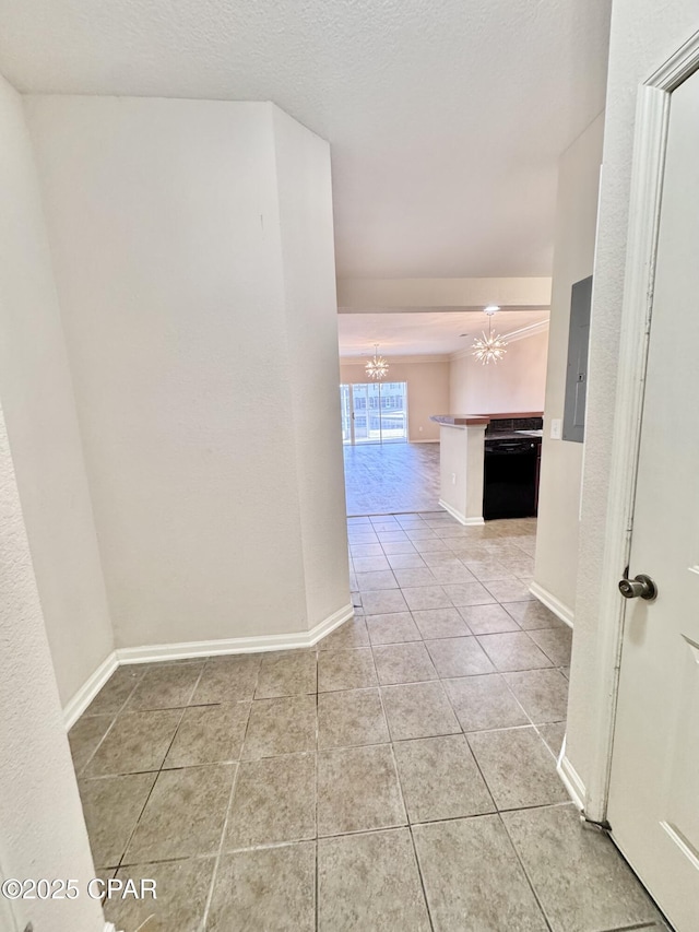 hall featuring light tile patterned floors, baseboards, electric panel, and an inviting chandelier