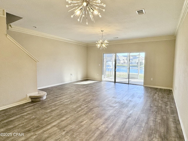 unfurnished living room featuring visible vents, ornamental molding, dark wood-type flooring, a water view, and an inviting chandelier