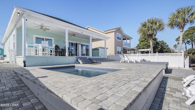 exterior space with a patio, fence, a ceiling fan, and a fenced in pool