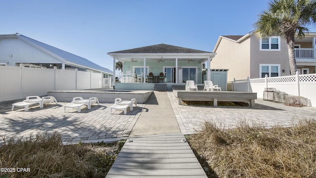 back of house with ceiling fan, a patio, fence, and stucco siding