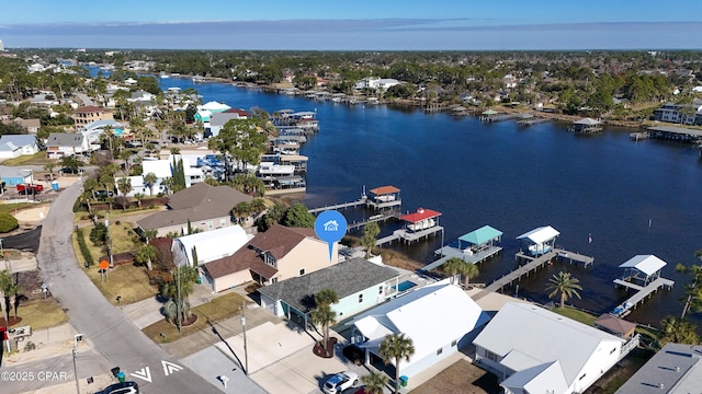 drone / aerial view with a water view and a residential view