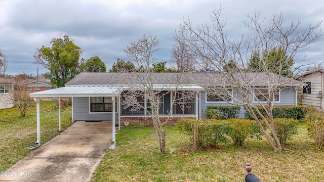 single story home featuring a carport, a front yard, concrete driveway, and brick siding