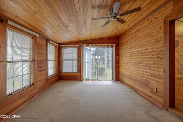 unfurnished sunroom featuring vaulted ceiling, wooden ceiling, and a wealth of natural light