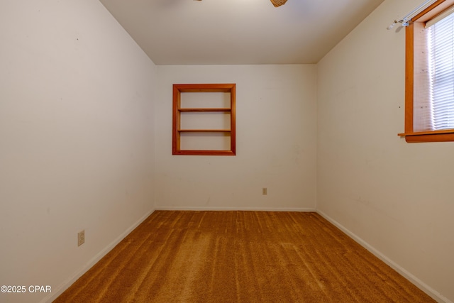 unfurnished room with baseboards and carpet flooring