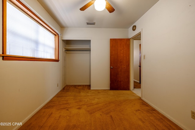 unfurnished bedroom with a closet, visible vents, baseboards, and carpet flooring