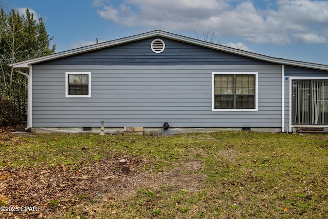 view of side of home with a lawn