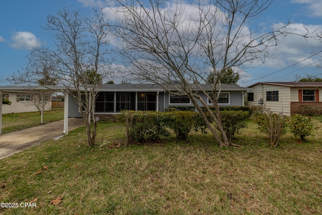 single story home with a carport, a front yard, a sunroom, and driveway