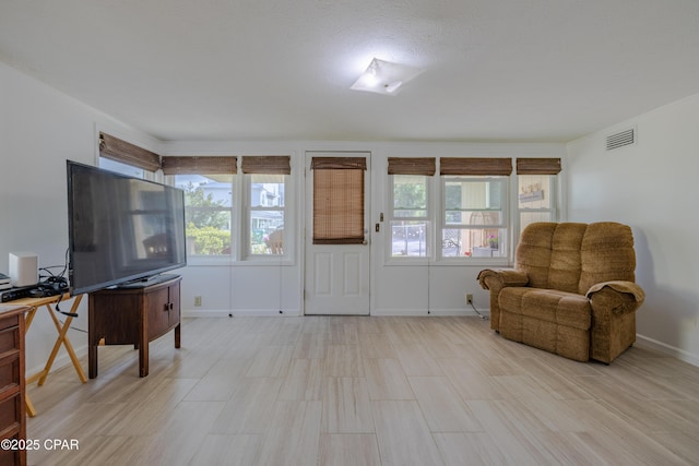 living area featuring visible vents and baseboards