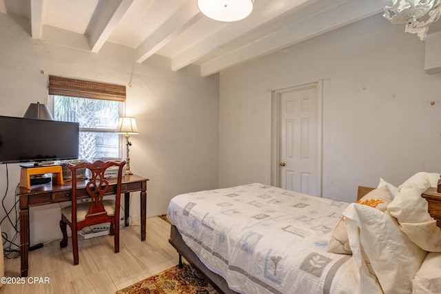 bedroom featuring beamed ceiling and light wood finished floors