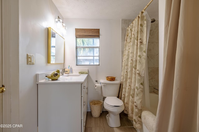 full bath with a textured ceiling, toilet, wood finished floors, vanity, and shower / bath combination with curtain