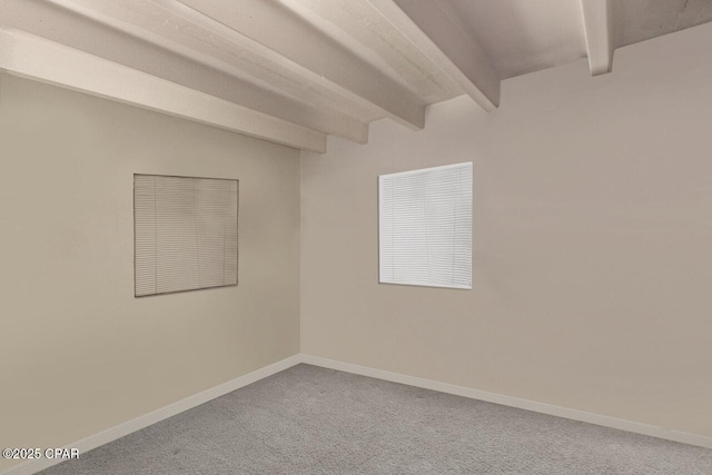 carpeted empty room with baseboards and beam ceiling