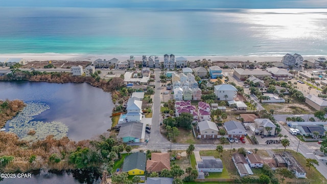 aerial view with a water view, a view of the beach, and a residential view