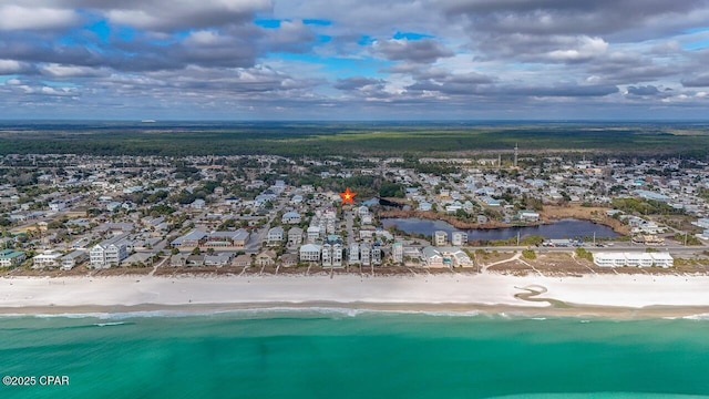 drone / aerial view featuring a water view, a residential view, and a view of the beach