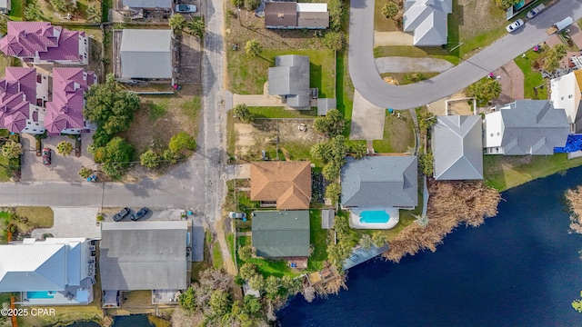 drone / aerial view featuring a water view and a residential view