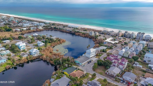 drone / aerial view with a beach view, a water view, and a residential view