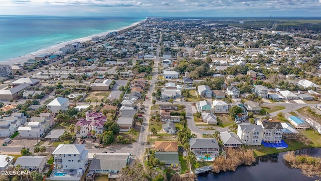 drone / aerial view featuring a residential view, a water view, and a beach view