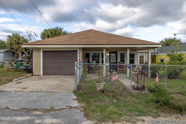 view of front facade featuring a garage, driveway, and fence