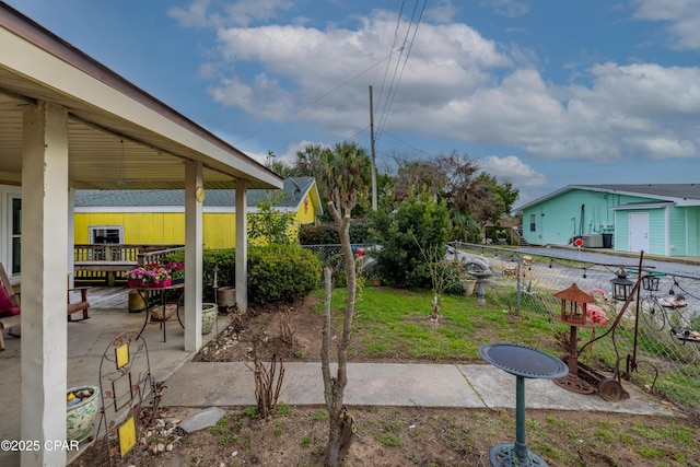 view of yard featuring fence and a patio