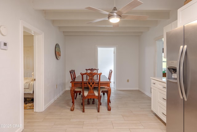 dining room featuring wood finish floors, beamed ceiling, baseboards, and ceiling fan