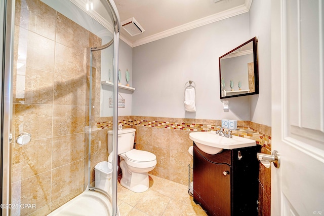 bathroom with ornamental molding, a stall shower, vanity, and tile walls