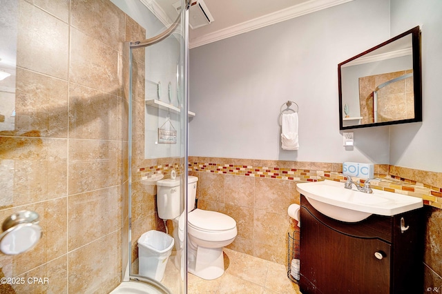 full bathroom with ornamental molding, a stall shower, vanity, and tile walls