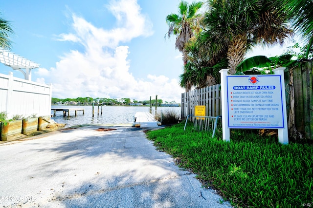 exterior space featuring a dock and fence