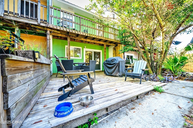 wooden deck featuring a grill