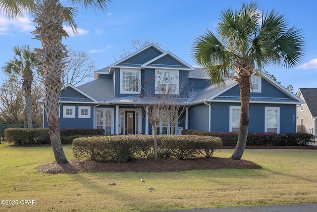 233 Moonlight Bay Dr, Panama City Beach, FL 32407 - traditional-style house with a front lawn and stucco siding