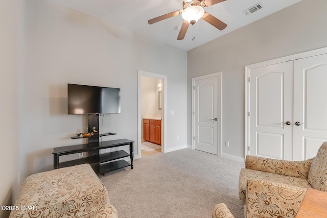 living area with light carpet, ceiling fan, visible vents, and baseboards