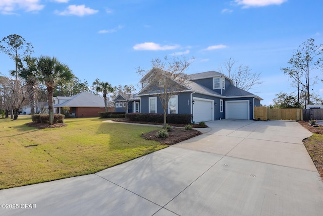 view of front of home with a garage, concrete driveway, a front lawn, and fence