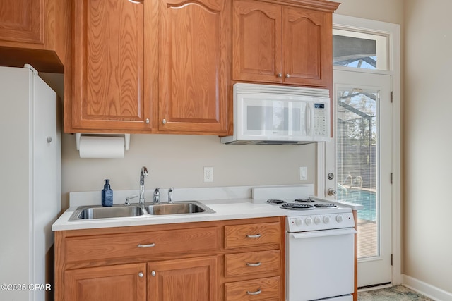 233 Moonlight Bay Dr, Panama City Beach, FL 32407 - kitchen with white appliances, light countertops, and a sink